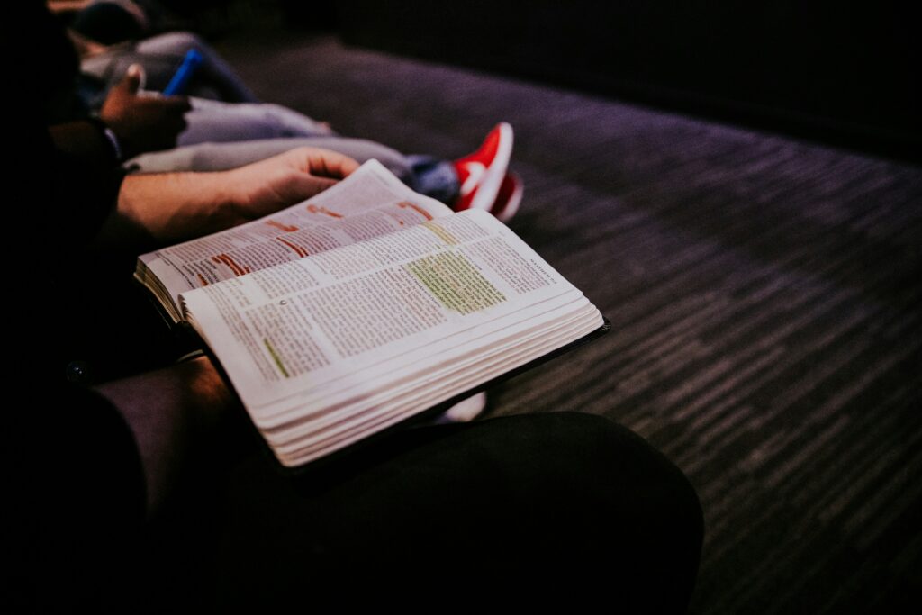 Person holding an open Bible.